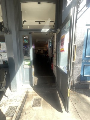 Glass and wooden green doors ahead. Pull gold metal handle on left centre to open.