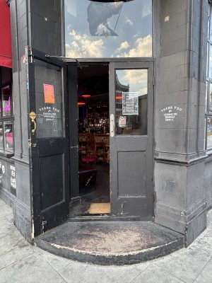 Black doors with glass panels ahead. Pull doors to open from center.