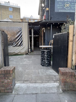 Black wooden doors ahead. Push from center to open.