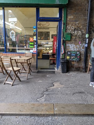 From pavement facing venue. One small step up before entrance and outdoor seating.
