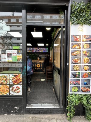 Glass door with black frames. Push from left to open.