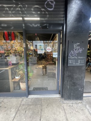 Glass door with black frame ahead. Door slides from right to left upon arrival.