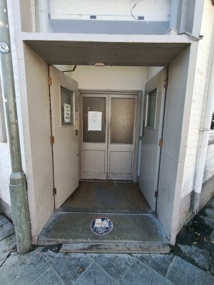 Grey preceding doors. Push from centre to open.