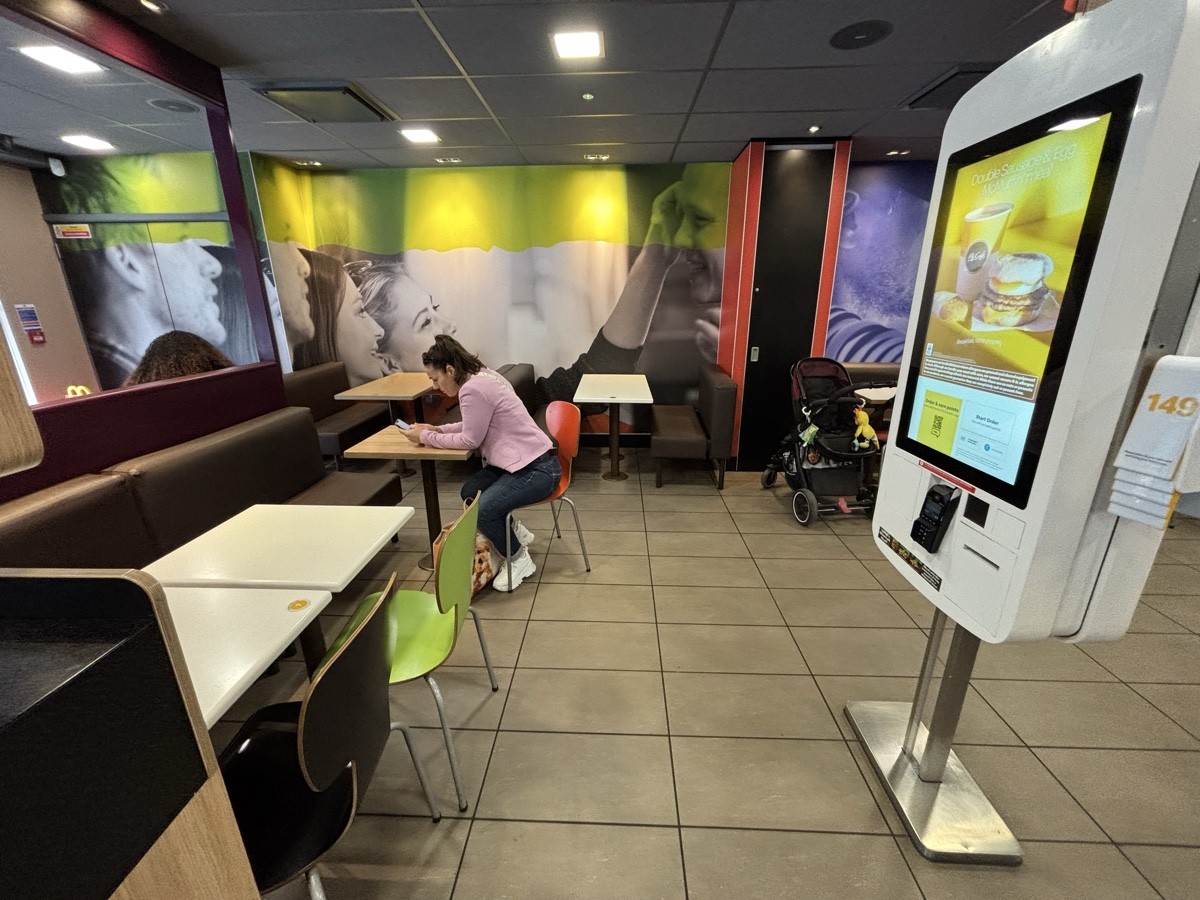 From after bins facing left. Half boot along left. Boot at the back. Self ordering screen on right.