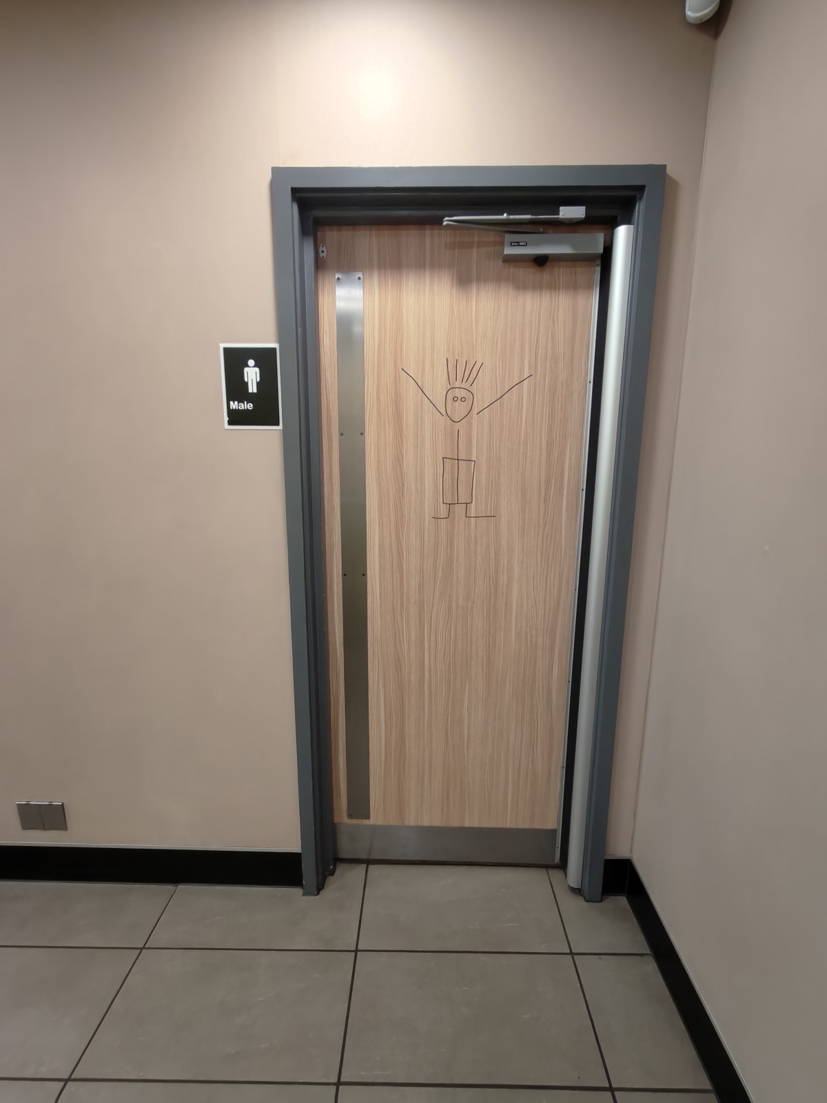 From top of stairs facing left. Non-accessible toilet ahead.