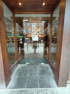 Glass door. Pull silver handle on left to open.
