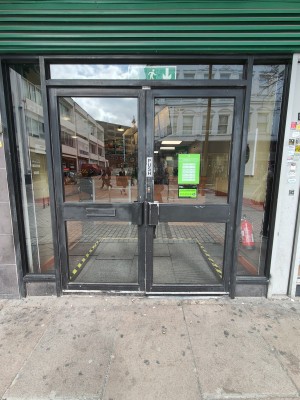 Black framed glass doors. Push black handles in centre to open.