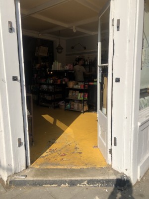 Glass doors with white frame. Push from centre to open.