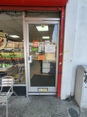 Silver framed glass door. Push silver handle on left to open.