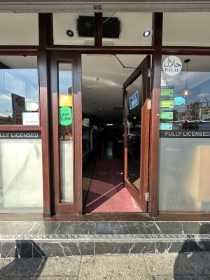Glass door ahead with wooden frame. Push from left to open.
