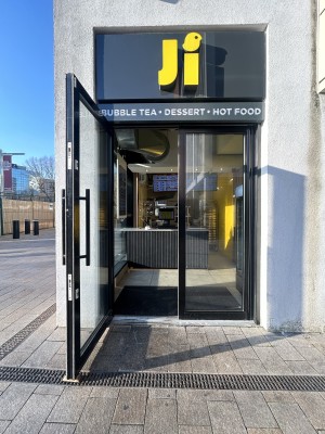 Glass doors ahead. Pull black handle in centre to open.
