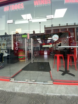 Glass doors ahead. Pull from metal handles in centre to open.