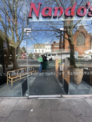 Glass door ahead. Push gold handle on right to open.