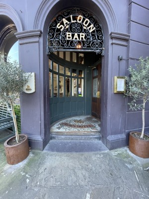 Open archway. One step up at foot of archway.