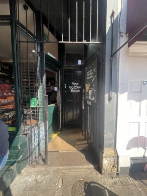 Metal gate ahead. Push from left to open. Gate remains open during opening hours.