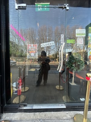 Glass door ahead. Push silver handle on right to open.