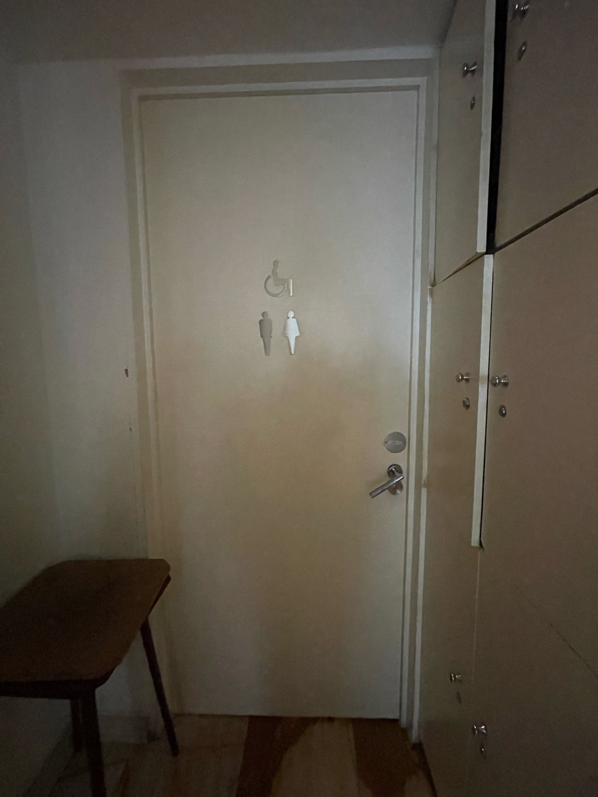 From end of path facing straight. White toilet door. Pull sliver handle on right.
