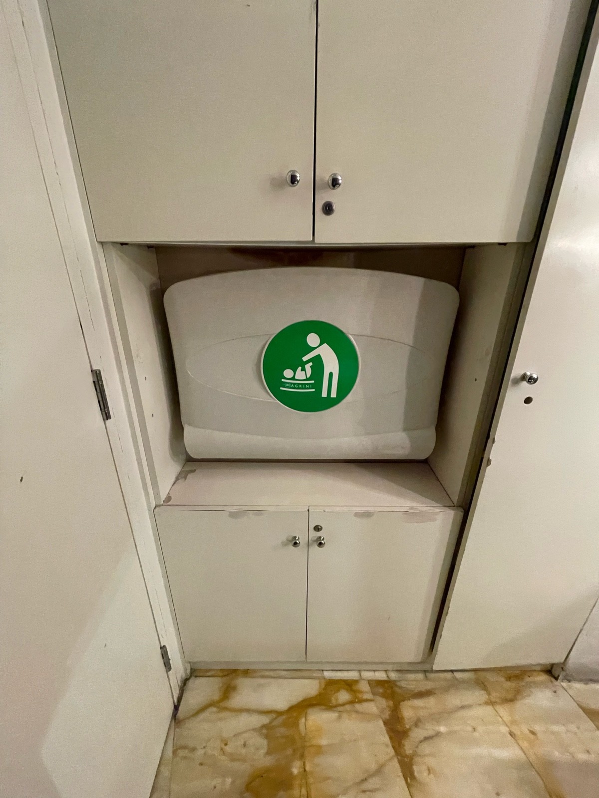 From doorway facing left. Baby changing station ahead.