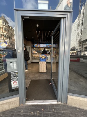 Grey and glass panelled doors. Push from metal handle on left to open.