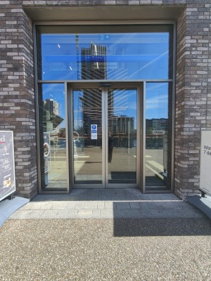 Grey framed glass doors. Doors slide open from centre.