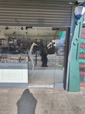 Glass door. Push silver handle on left to open.