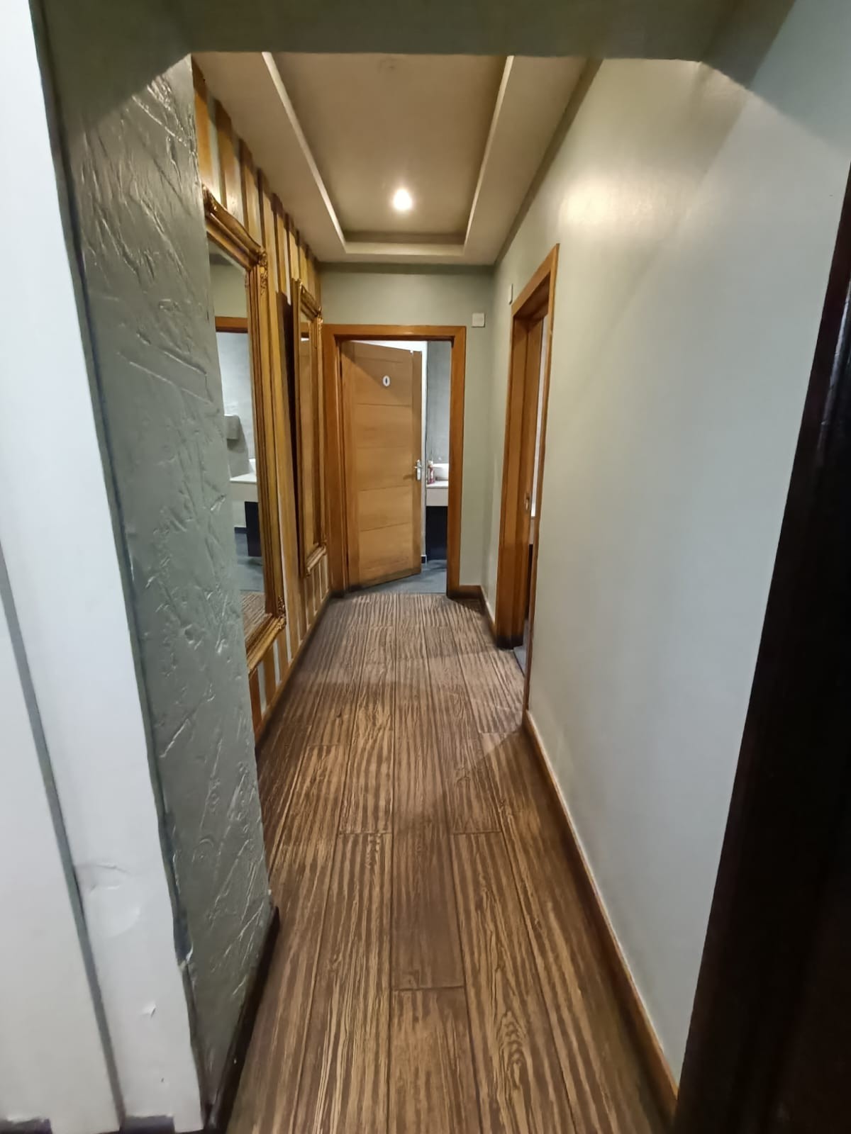 From archway facing left. Second archway ahead to path to bathroom at back.