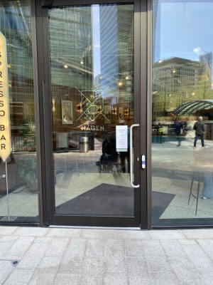 Glass door with green frame ahead.