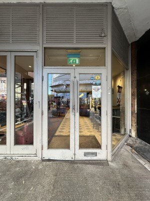 Glass doors with grey frame. Pull silver handles from top centre to open.