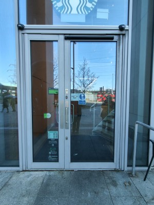 Grey framed glass doors. Pull silver handle on right to open.