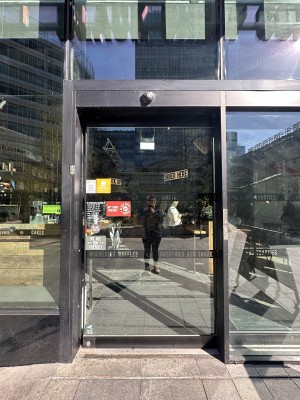 Glass door with black frame. Doors slide open from left.