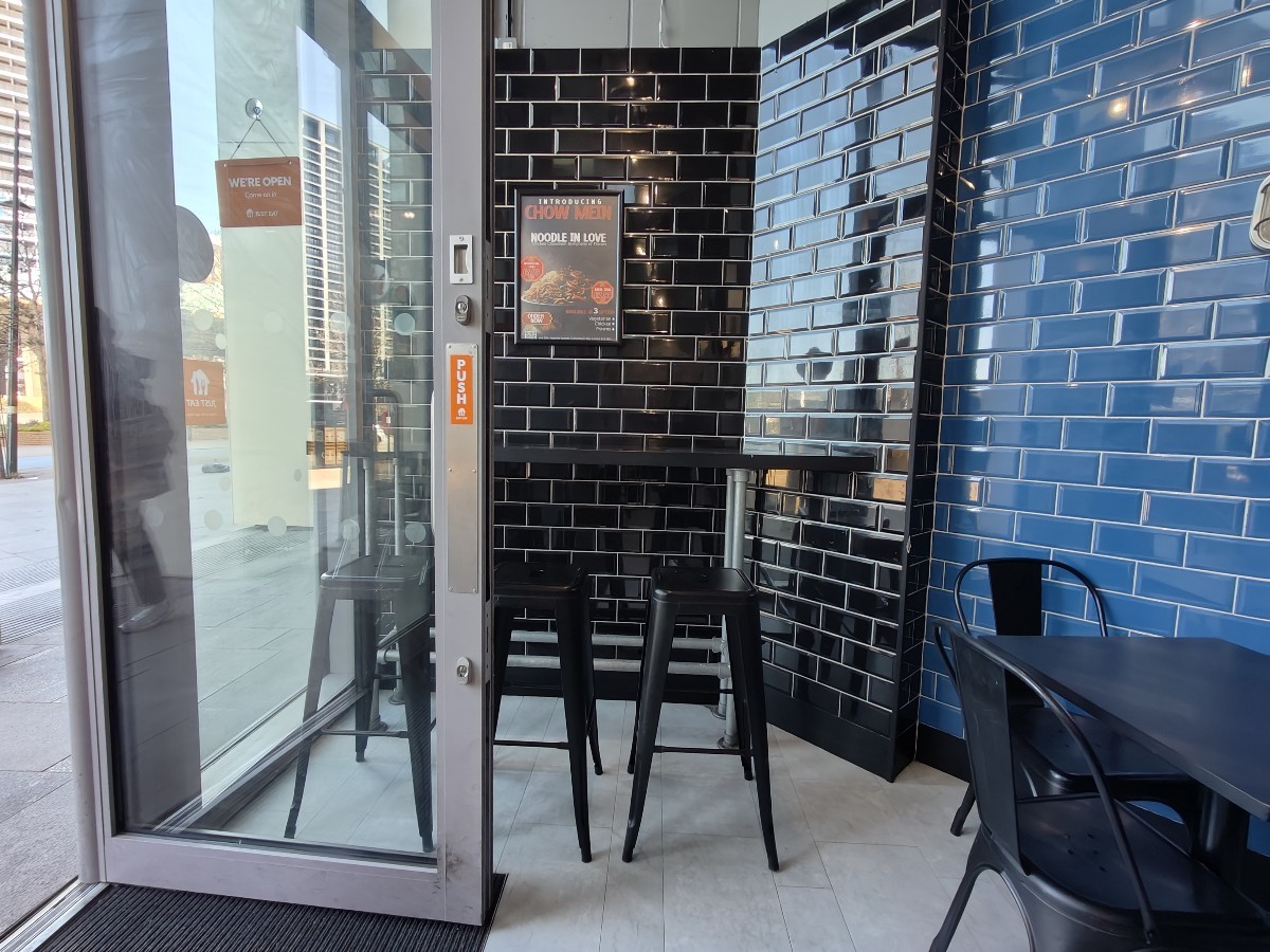 From entrance facing left. High table and stools at back.
