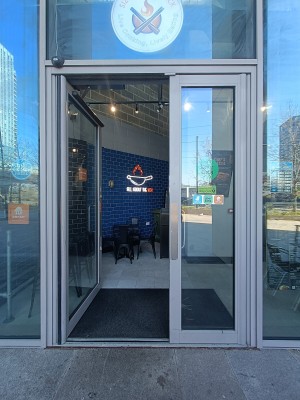 Glass doors with grey frame. Push from middle to open.