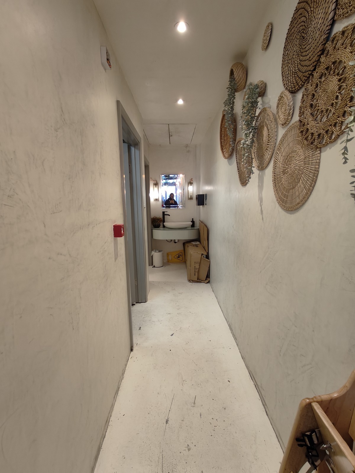 From archway facing straight. Path ahead to sink at back. Toilet to its left.