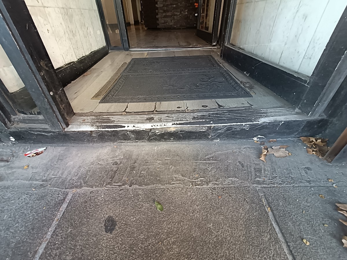 Step up before doorway, doormat after.