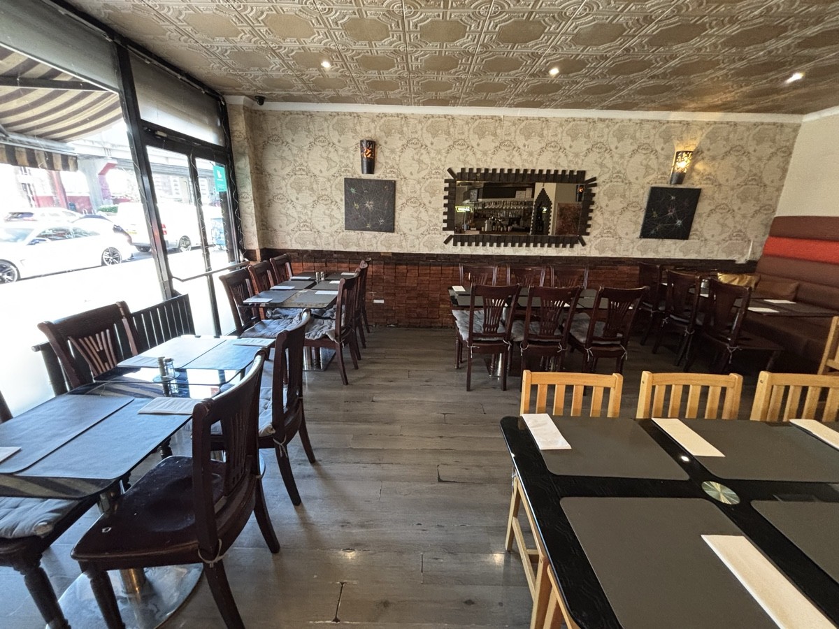 From left end of table facing straight. Table and chairs along left and right.