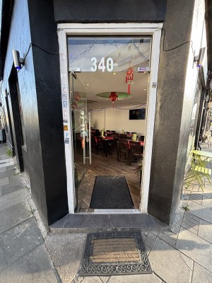 Glass door with metal frame ahead. Push from right to open.
