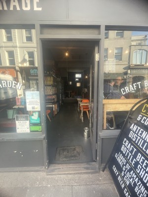 Grey wooden and glass door ahead. Push silver metal handle on left to open.