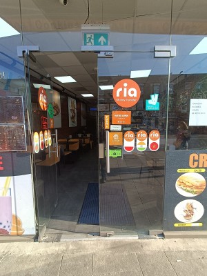 Glass doors with silver handles in middle. Push to open.