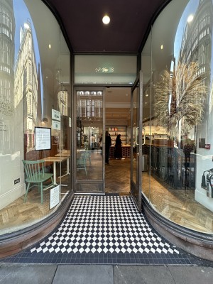 Brown and glass panelled doors ahead. Pull in middle to open.