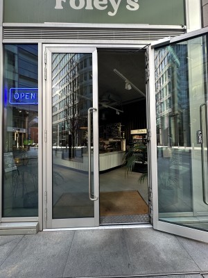 Glass doors with grey frame. Pull silver handles from centre to open.