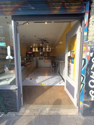 Glass doors with grey wooden frames. Push silver handles in middle to open.