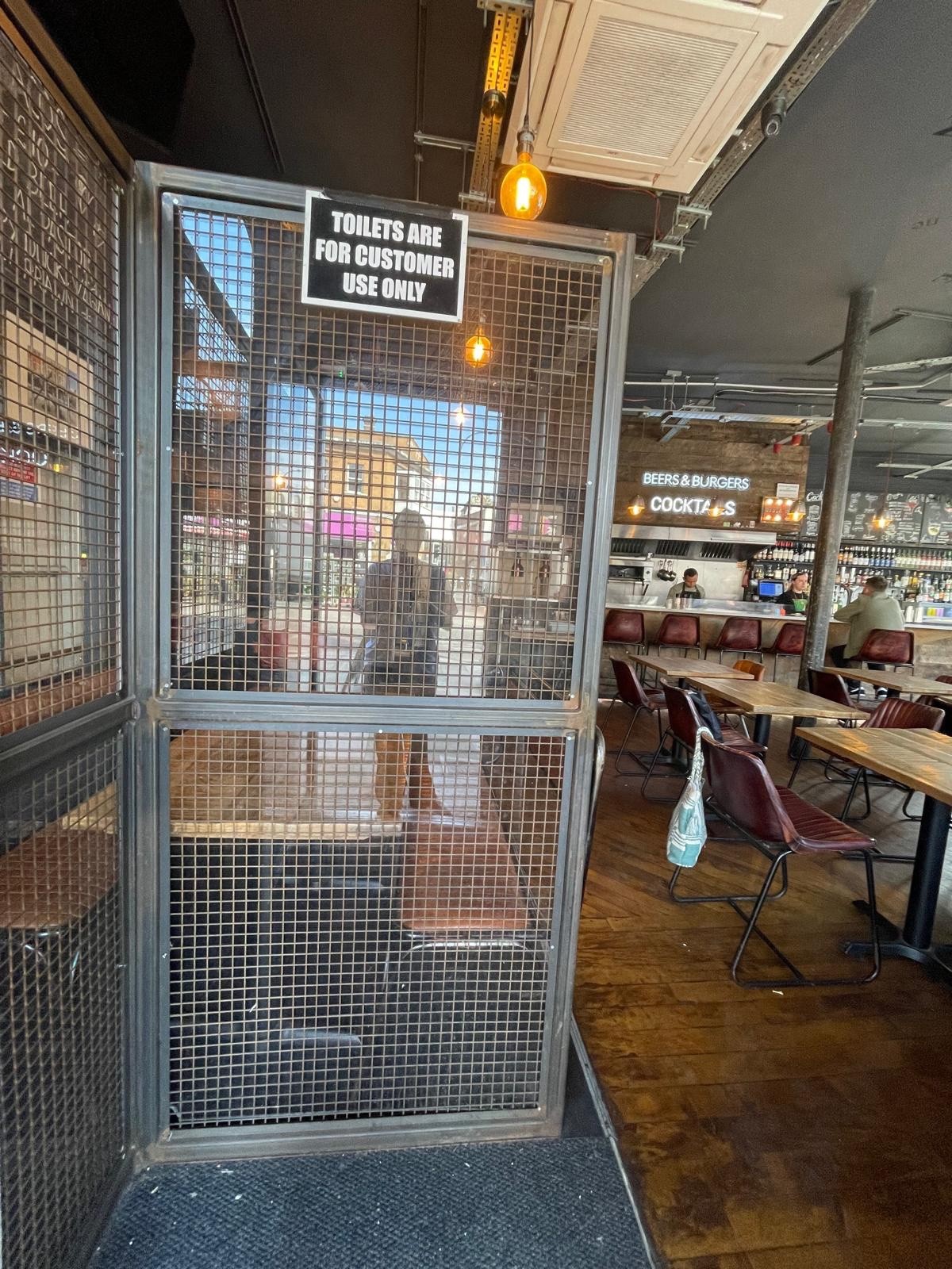 From entrance facing straight, glass partition ahead.