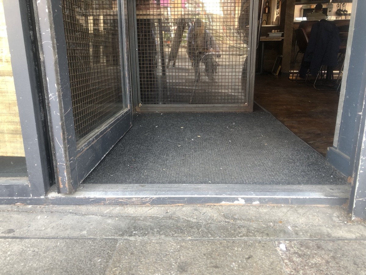 Step up at foot of entrance followed by doormat.