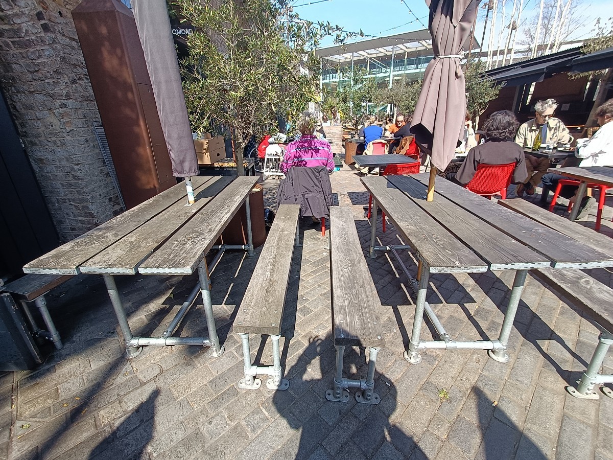 From entrance, looking right. Tables and benches ahead.