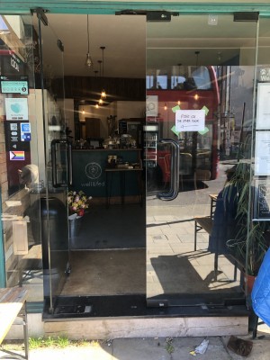 Glass doors, push black handle in centre to open.