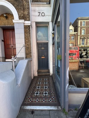 From left end of pavement facing venue. Path ahead. Entrance door to back right.