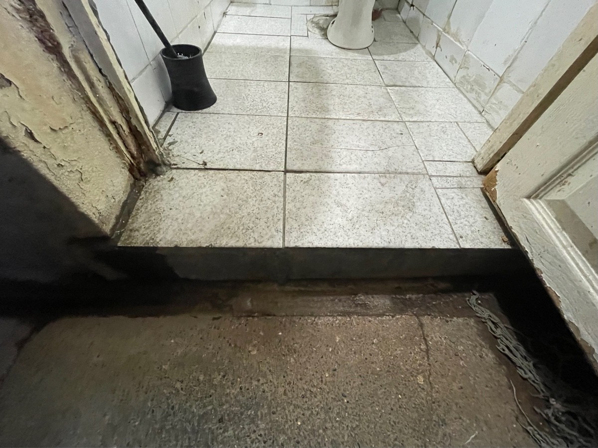 Step up at foot of door.