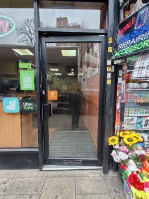 Black framed glass door. Push black handle on left to open.