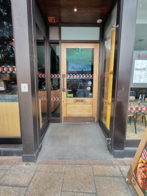 Opening to entrance door at back. Wooden framed glass door. Pull dark grey on left to open.
