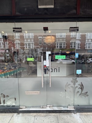 Glass doors with metal handles ahead. Push from center to open.